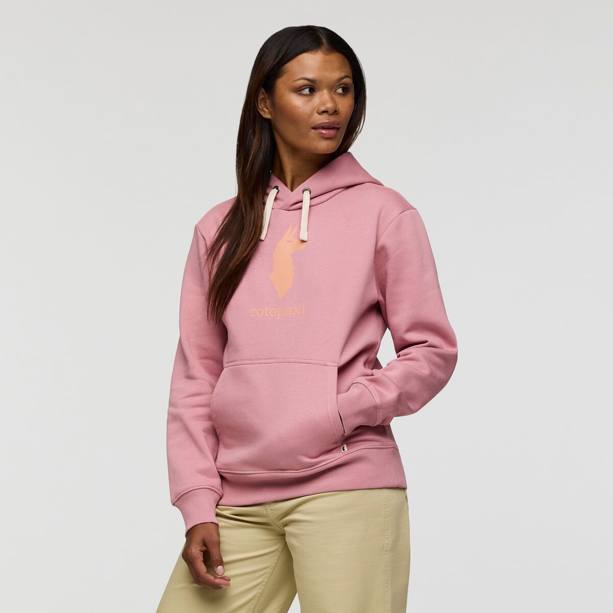 Pale rose pink hoodie with peach llama logo by Cotopaxi.