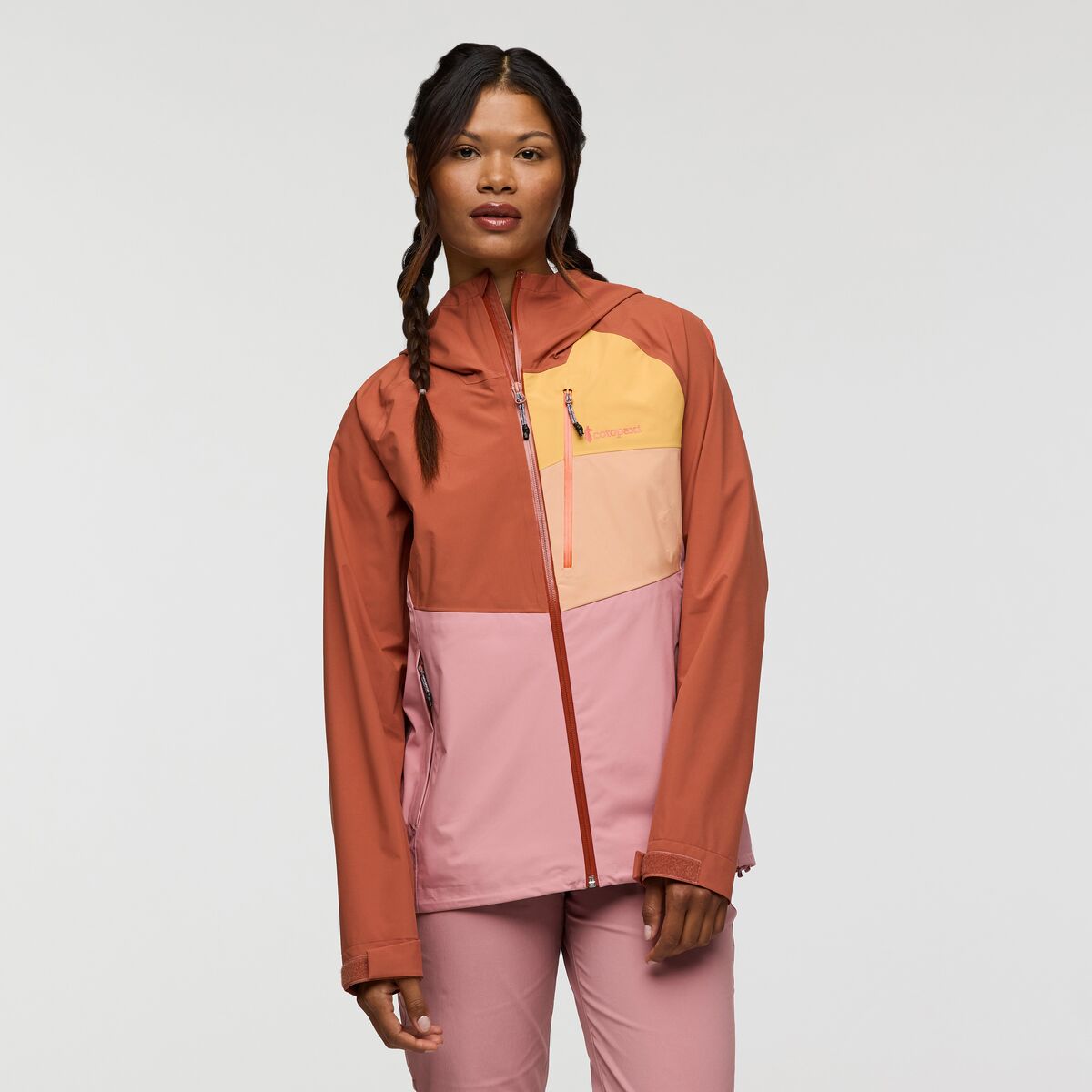 Orange, yellow, and pink hooded shell jacket by Cotopaxi.