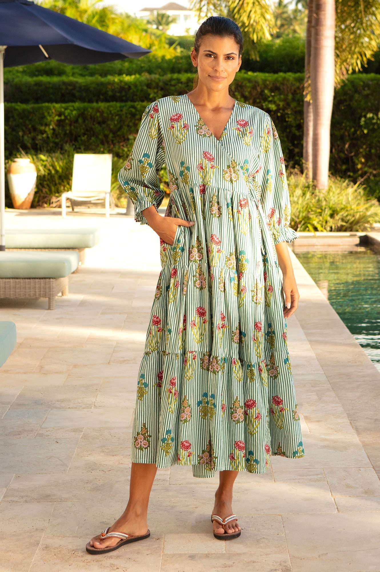 Green and white striped dress with floral print, V-neckline, and gathered waist.