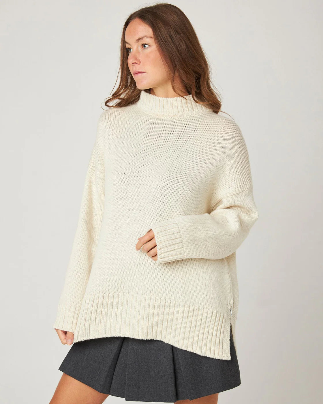 Model wears a cream ecru merino wool knitted sweater from Peregrine Clothing, filtered for the Light Spring, Clear Spring, and Warm Spring colour seasons.