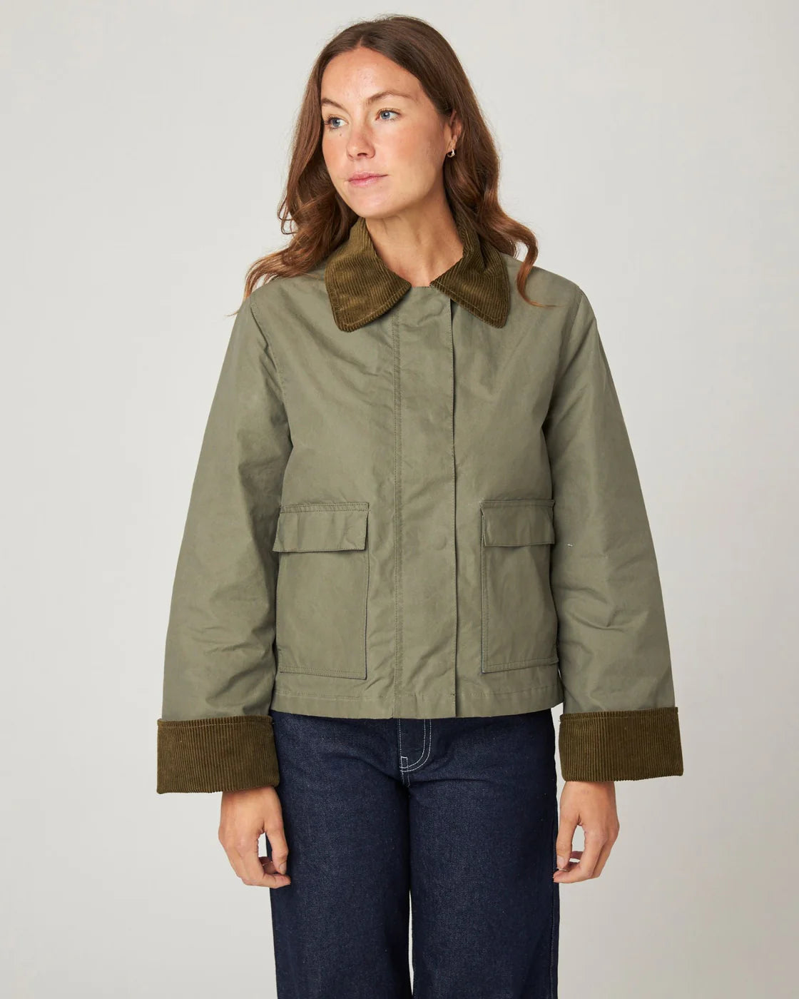 Model wears pale olive green waxed cotton jacket with soft brown corduroy collar and cuffs. Made by Peregrine Clothing and filtered for the Soft Autumn colour season by Shop My Palette.