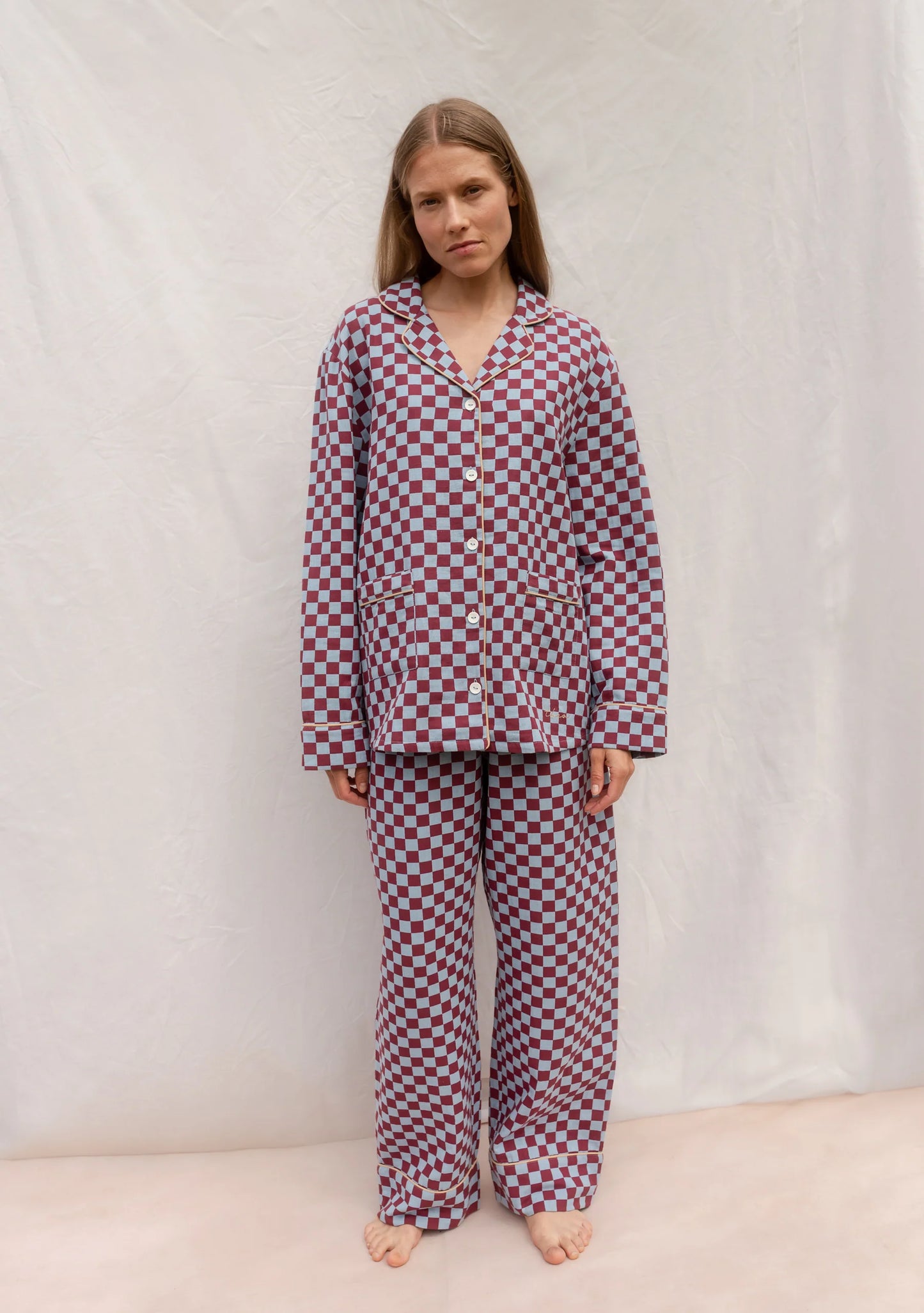 Person wearing a burgundy and blue checkered pajama set by TBCo against a plain background, filtered by Shop My Palette for the Cool Summer and Light Summer colour seasons.