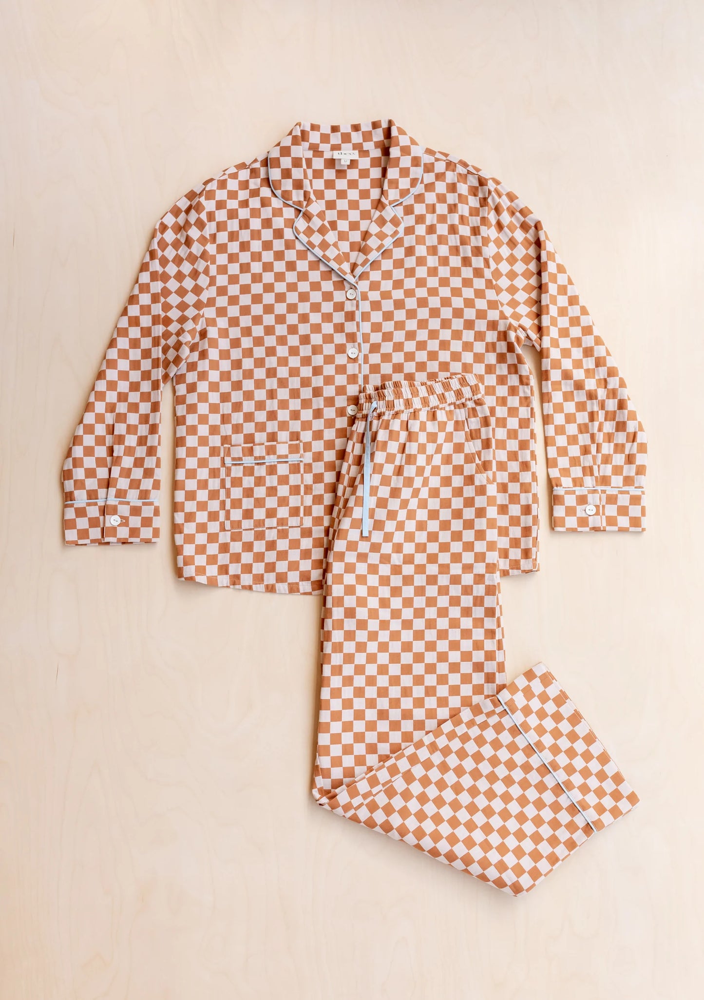 Checkered pyjama set on a beige background. Pyjamas are by TBCo and are filtered by Shop My Palette for the Light Spring, Warm Spring, Warm Autumn, and Soft Autumn colour seasons.