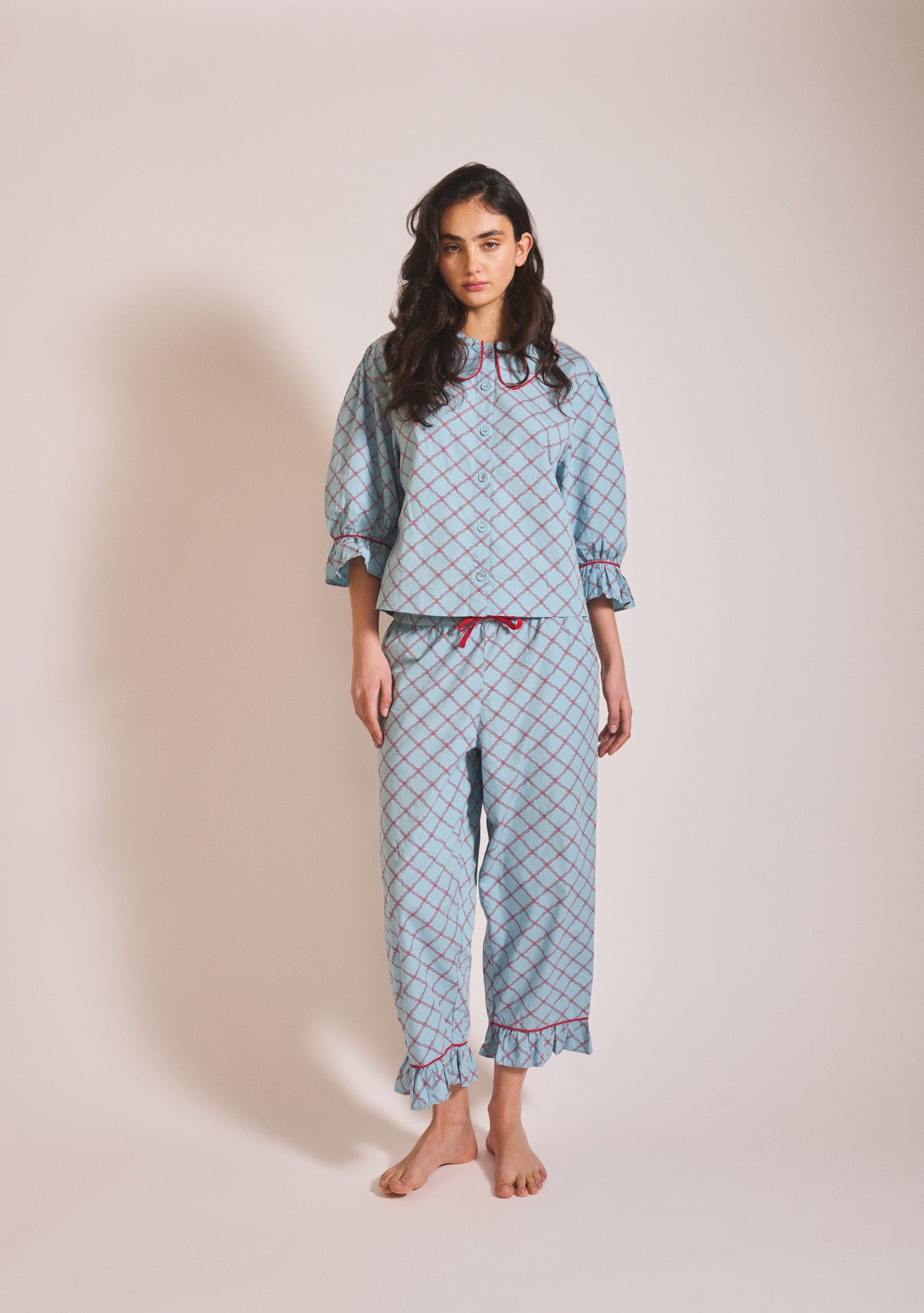Light blue patterned long-sleeve pyjama set with button-up top, Peter Pan collar, and matching trousers.