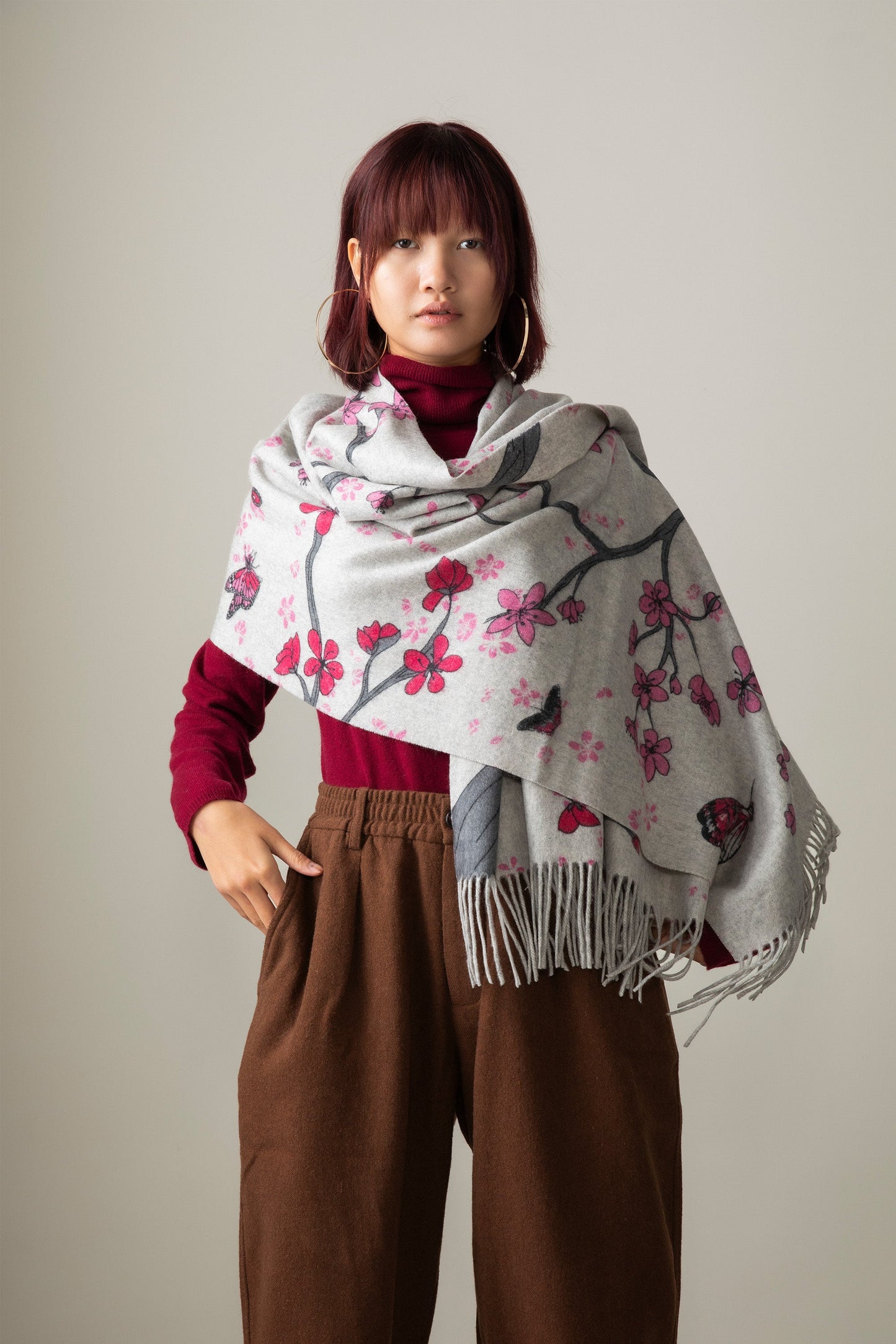 Grey cashmere fringed shawl with red and pink cherry blossom pattern.