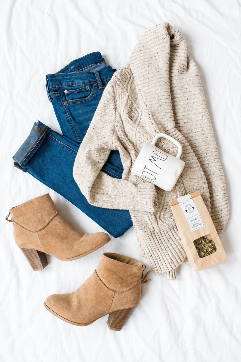 Oatmeal cardigan, indigo jeans, camel boots and a mug.