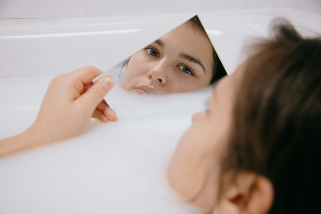 Woman looking in the mirror.