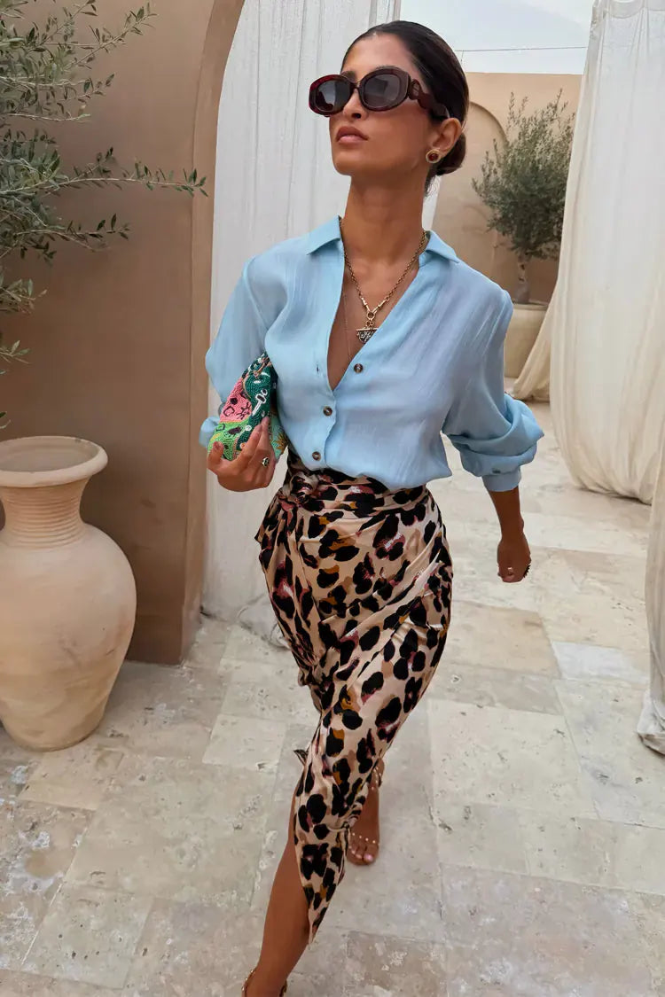 Model wears a pale blue shirt and leopard print skirt from Never Fully Dressed.