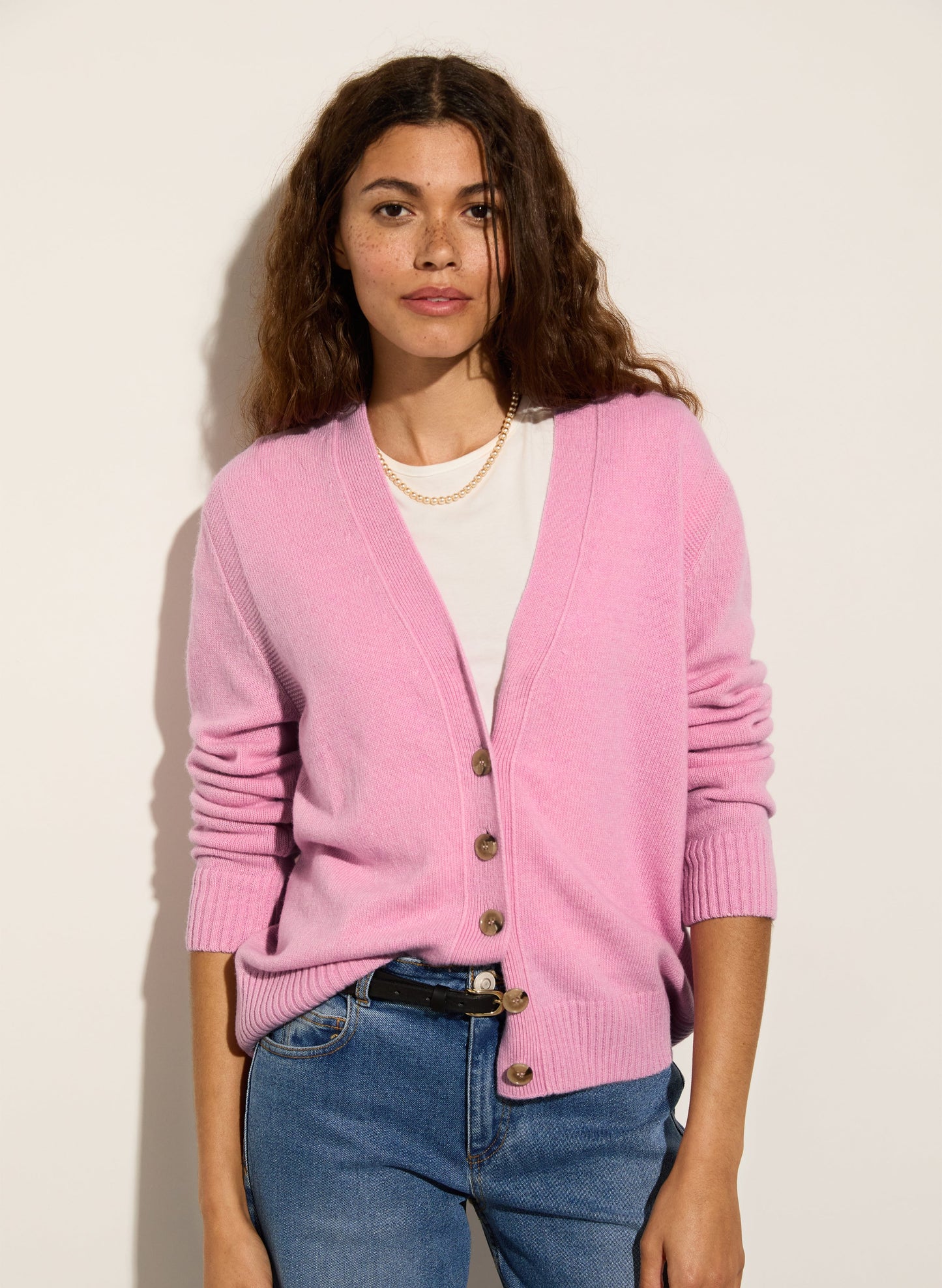 Light pink merino wool v-neck cardigan.