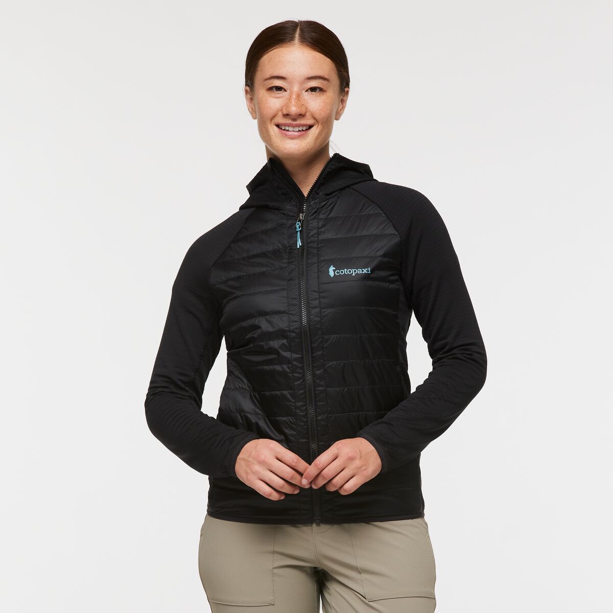Black hooded quilted jacket by Cotopaxi.