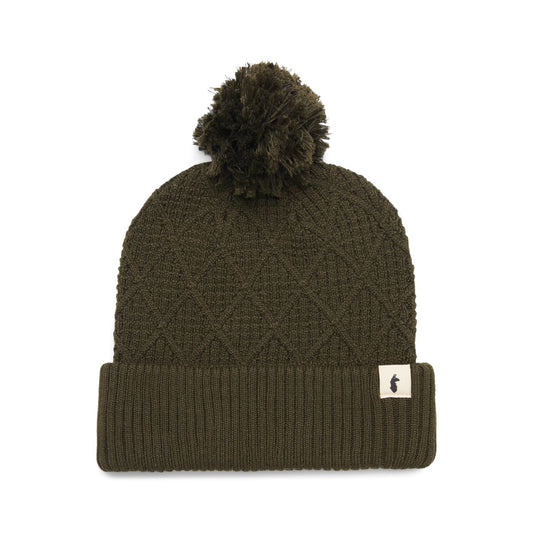 Deep olive knitted beanie hat with pompom by Cotopaxi.