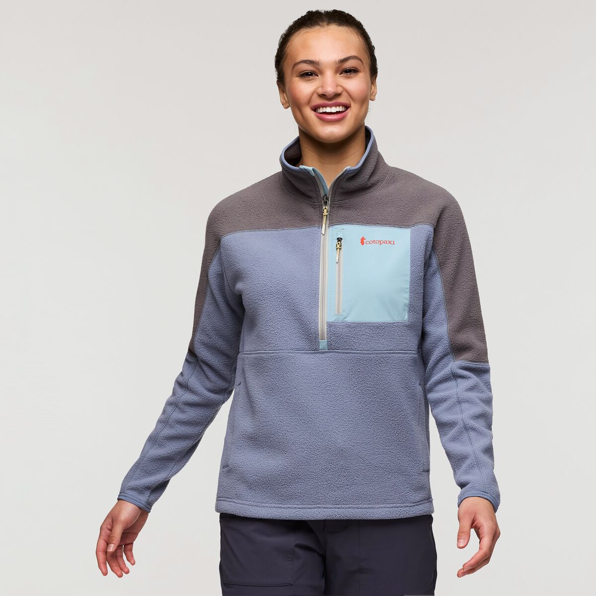 Half zip fleece by Cotopaxi in soft blue and dove grey.