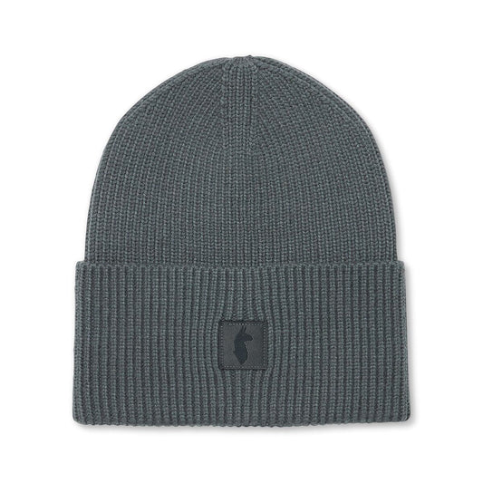 Charcoal knitted beanie by Cotopaxi with llama patch.