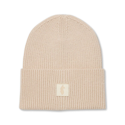 Cream knitted beanie with Cotopaxi llama patch.