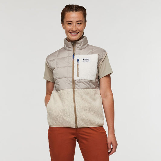 Two-tone cream and beige zip-up puffer vest with fleece lower half and pocket, by Cotopaxi.