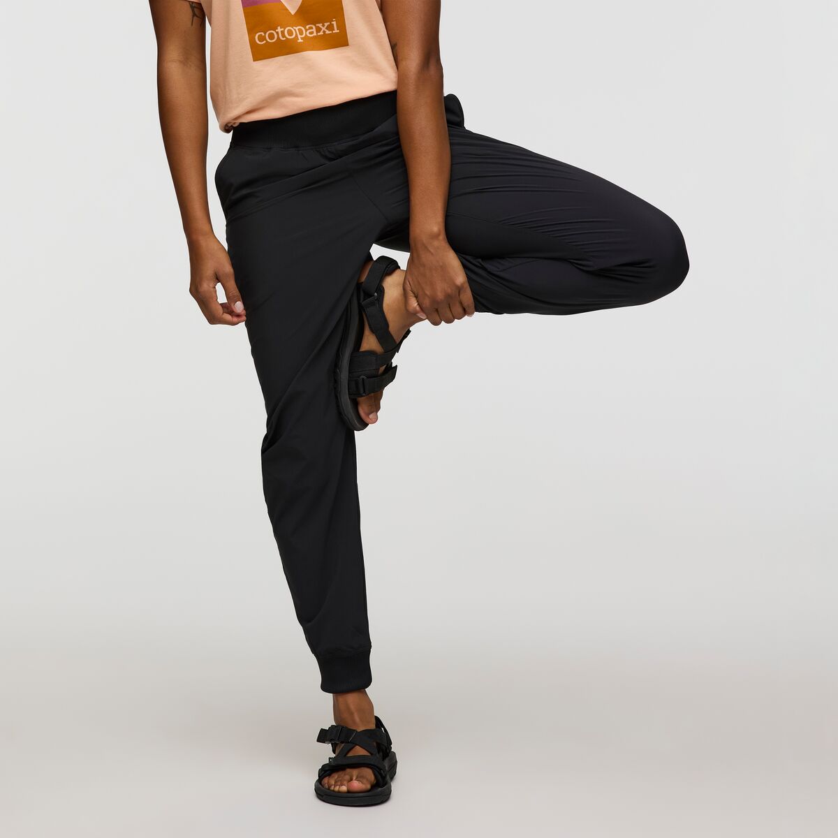 Black tracksuit bottoms by Cotopaxi.