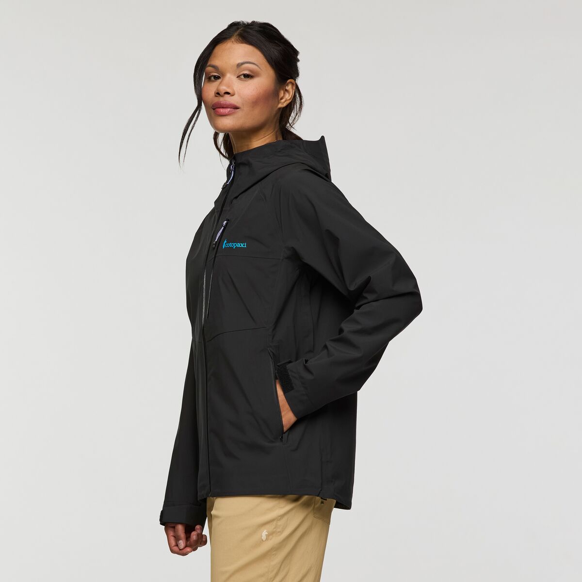 Black hooded shell jacket by Cotopaxi.