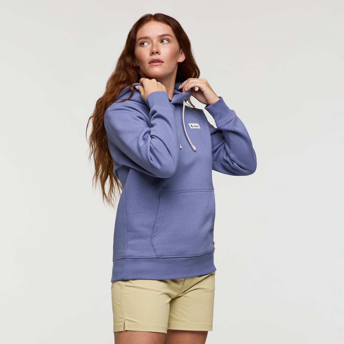 Lavender blue hoodie with Cotopaxi logo patch.
