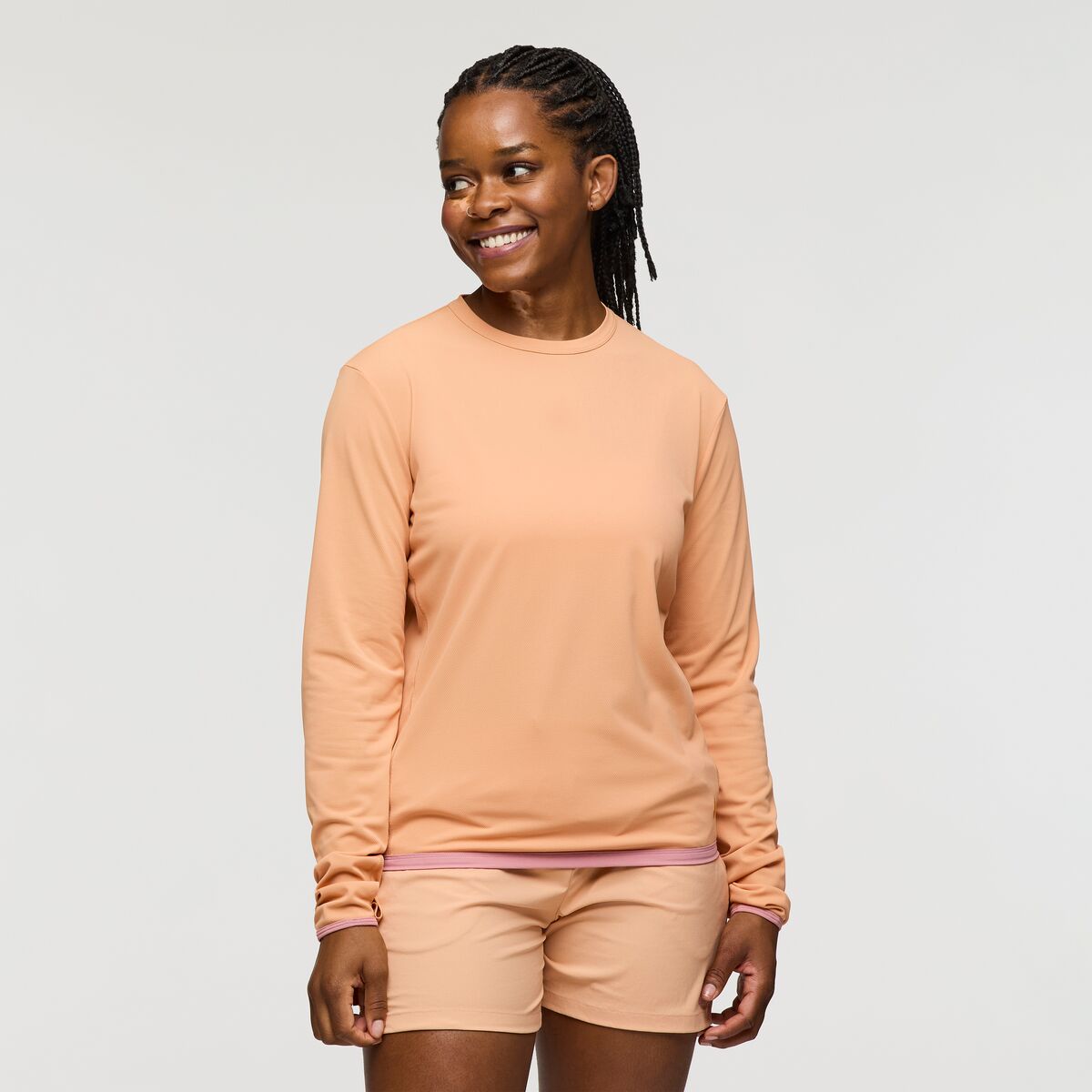 Warm peach coloured UPF 50+ long sleeve sun shirt by Cotopaxi.