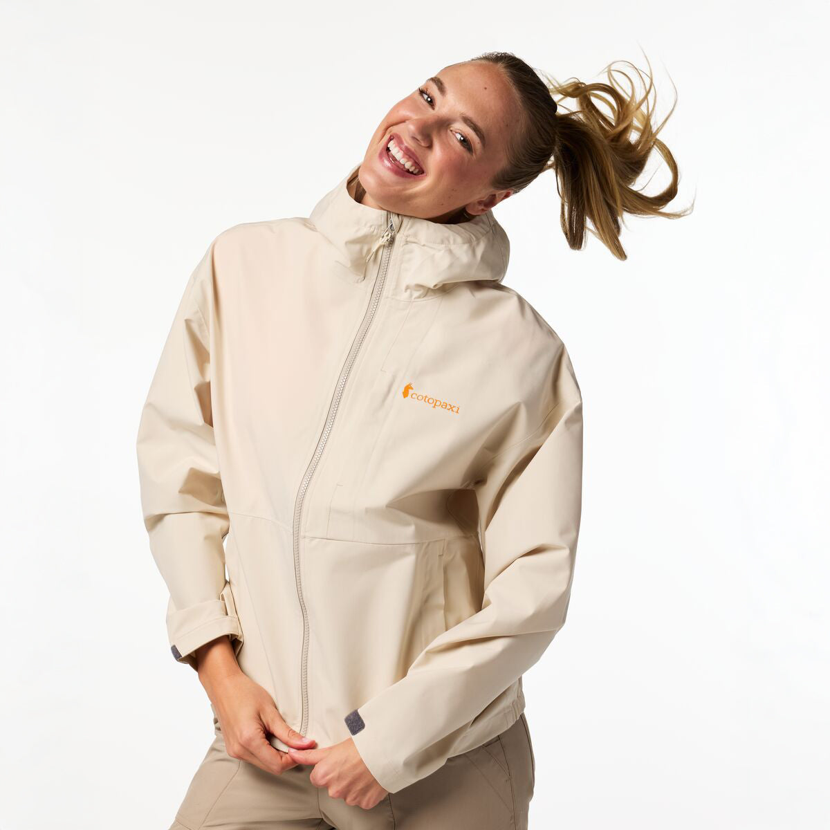 Cream hooded raincoat by Cotopaxi.