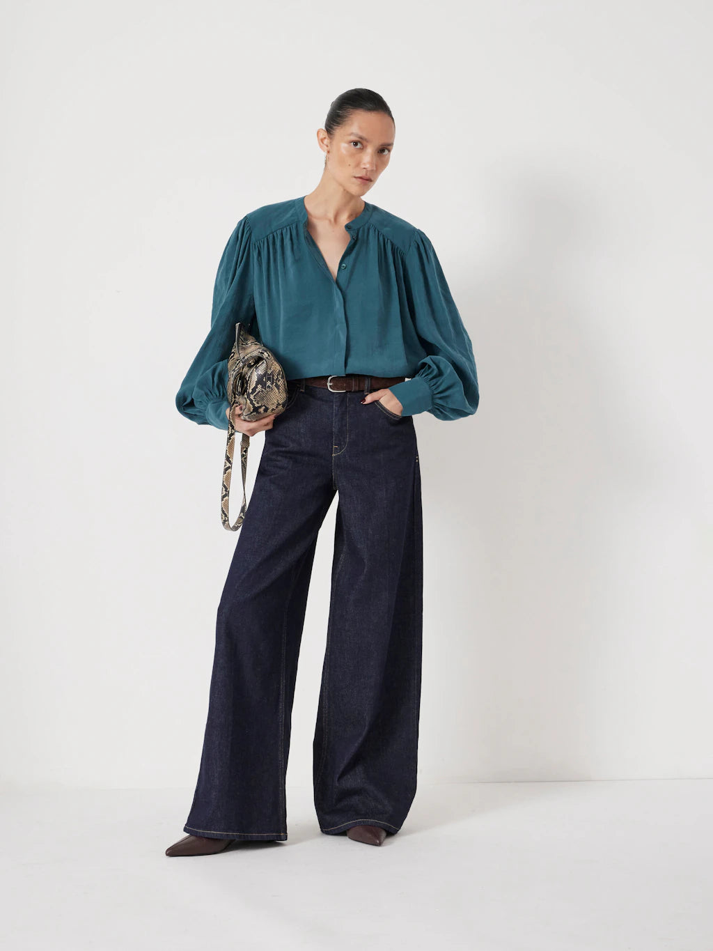 Teal puff-sleeve blouse.