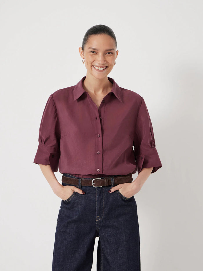 Muted burgundy shirt.