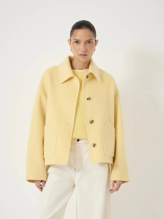 Butter yellow cropped wool jacket with buttons.
