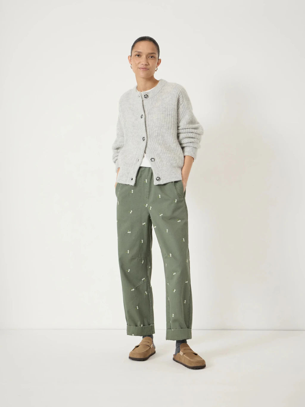 Soft green cotton barrel leg trousers with floral embroidery.
