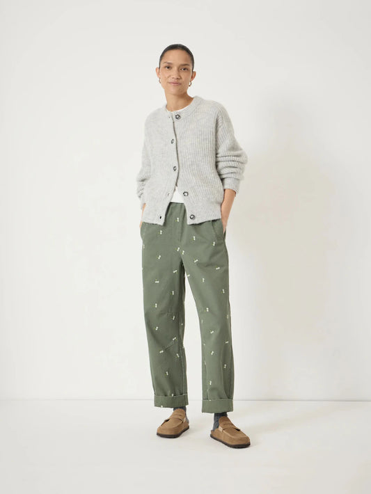 Soft green cotton barrel leg trousers with floral embroidery.