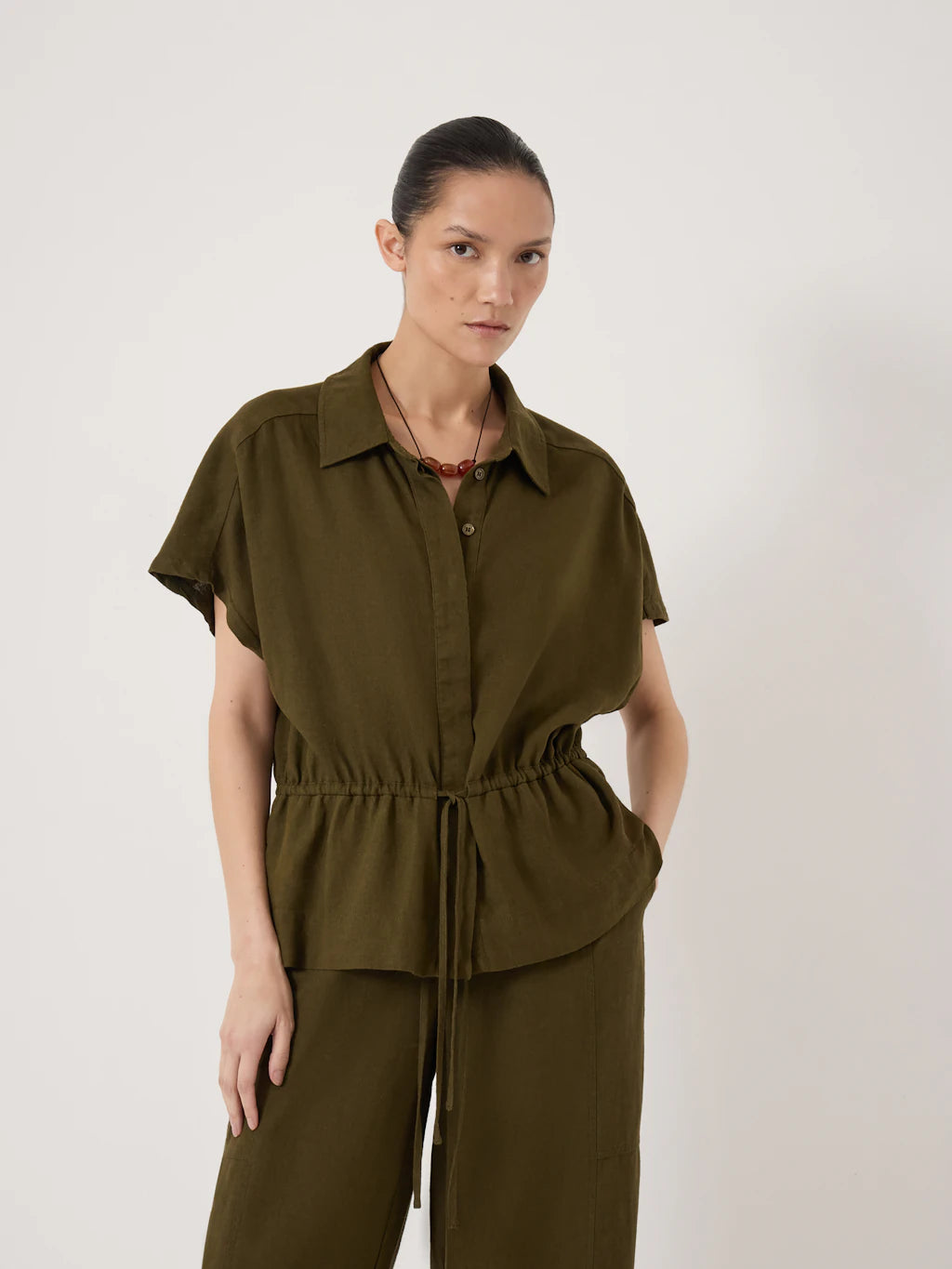 Deep olive button down blouse with drawstring waist.