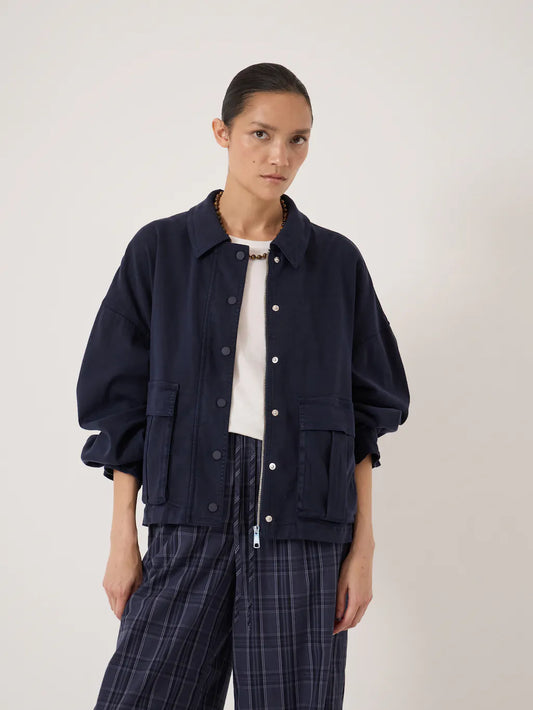 Deep navy utility jacket with silver buttons and zip.