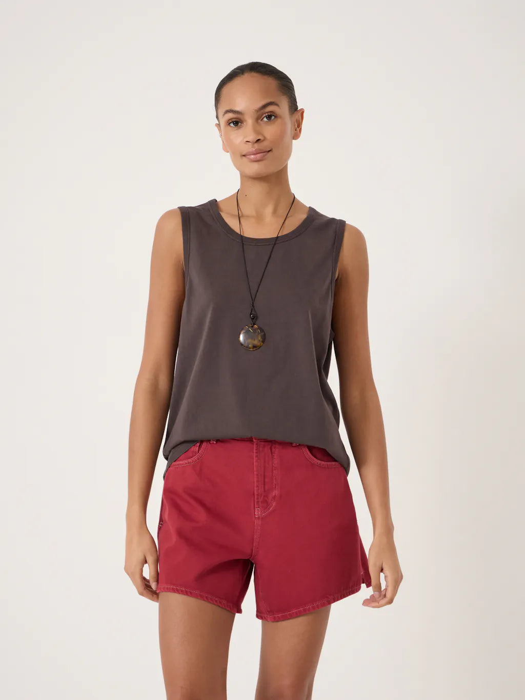 Muted brown sleeveless tank top in a soft draped fabric with a round neckline.