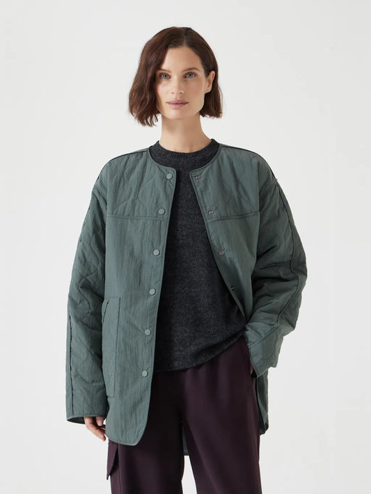 Slate grey quilted jacket with a relaxed fit and snap buttons