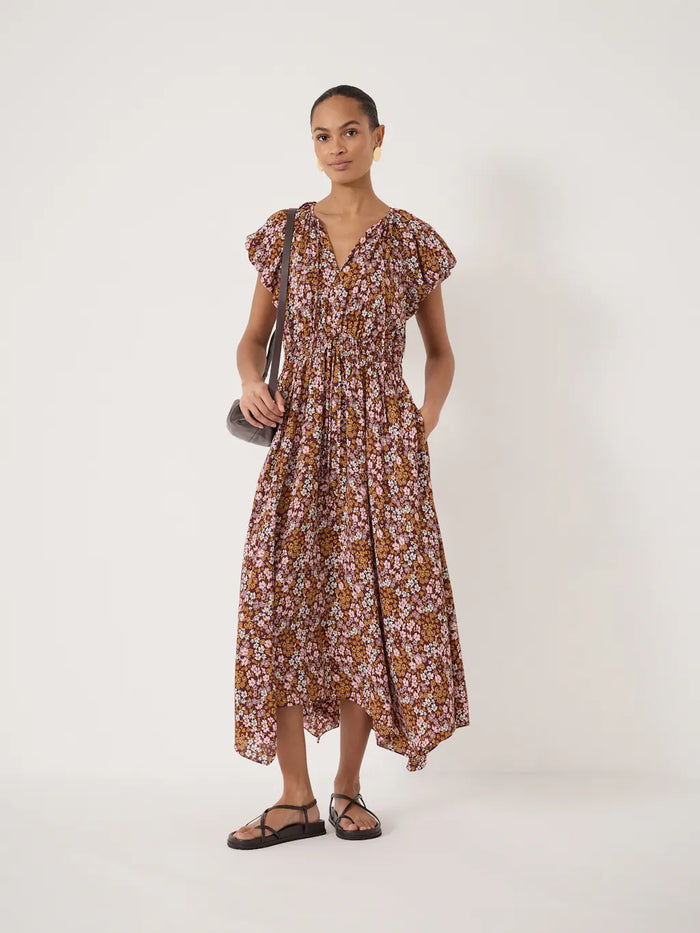 Short sleeved floral dress with bubble sleeves, v-neck, and handkerchief hem.