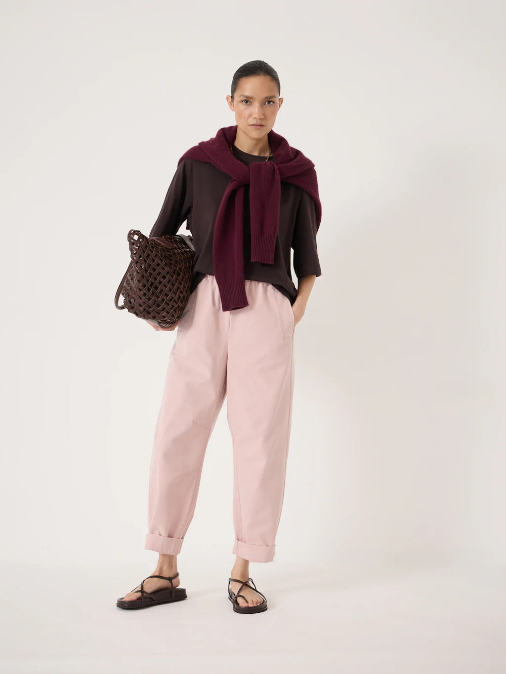Pale pink cotton barrel leg trousers.