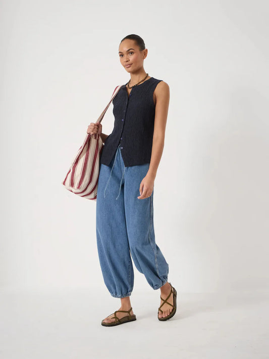 Mid-wash blue relaxed-fit jeans with a slightly tapered leg and elasticated cuffs.