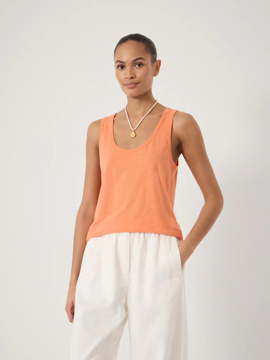 Soft peach sleeveless tank top with a scoop neckline in a lightweight fabric.