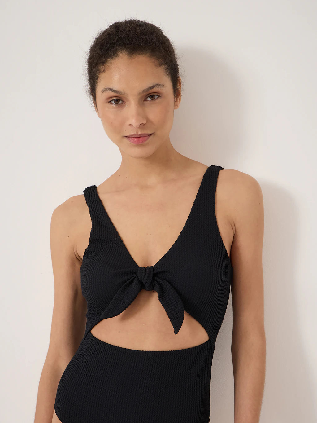 Black crinkle fabric tie-front swimsuit.