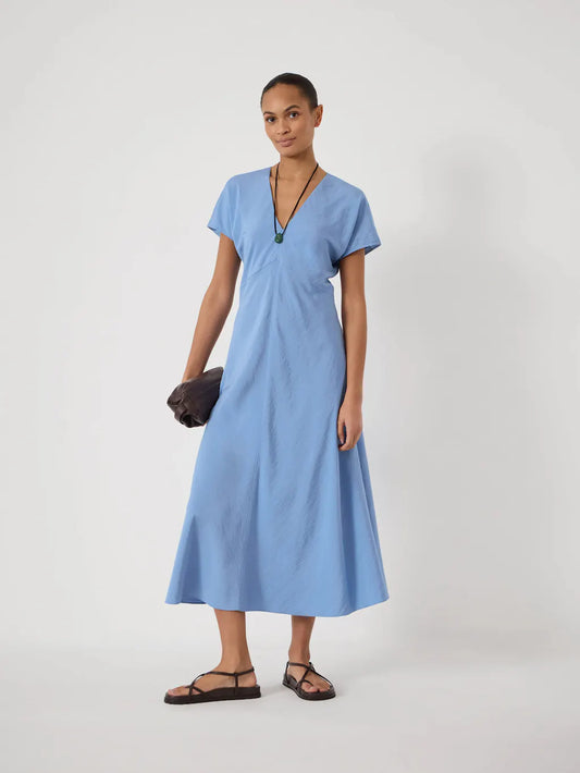 Light blue v-neck dress.