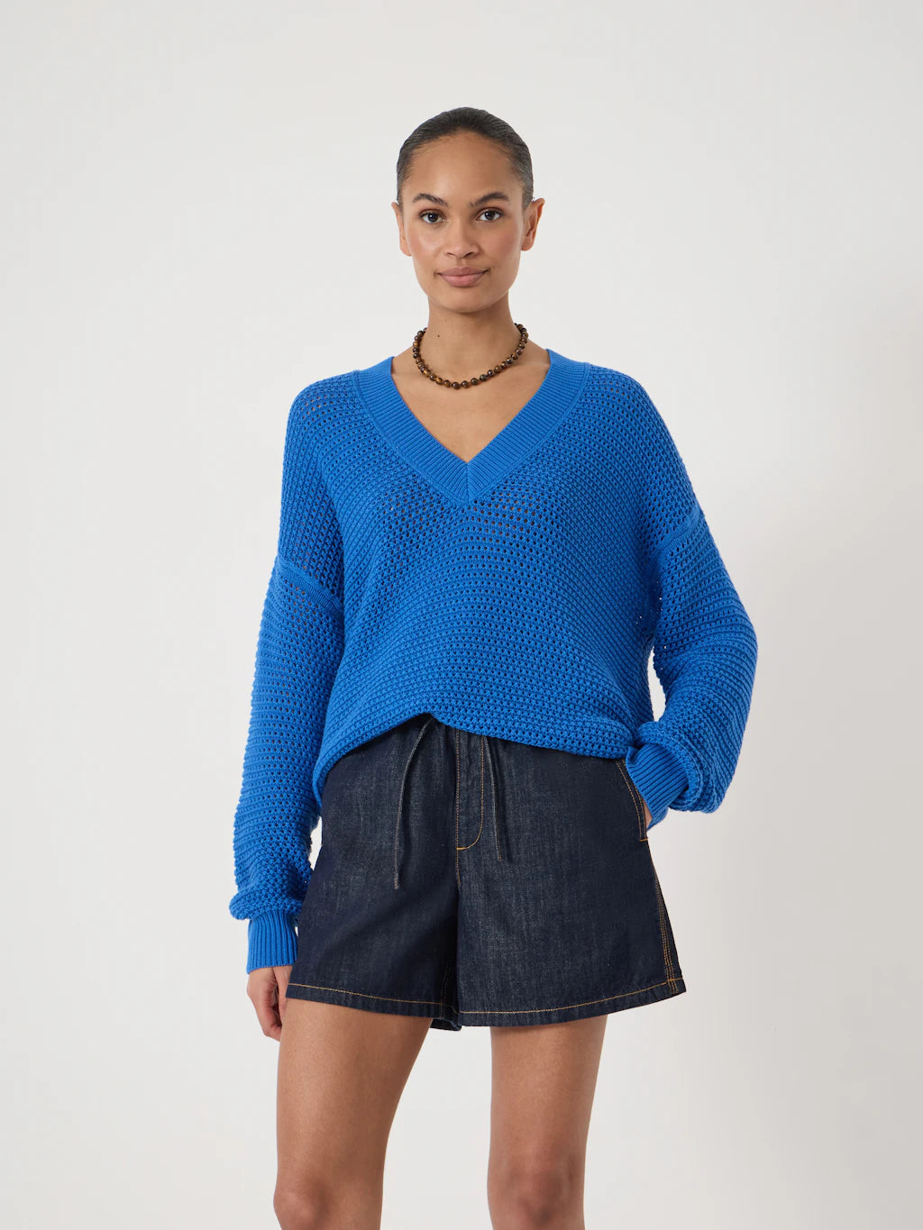 Open-knit v-neck cobalt blue jumper.