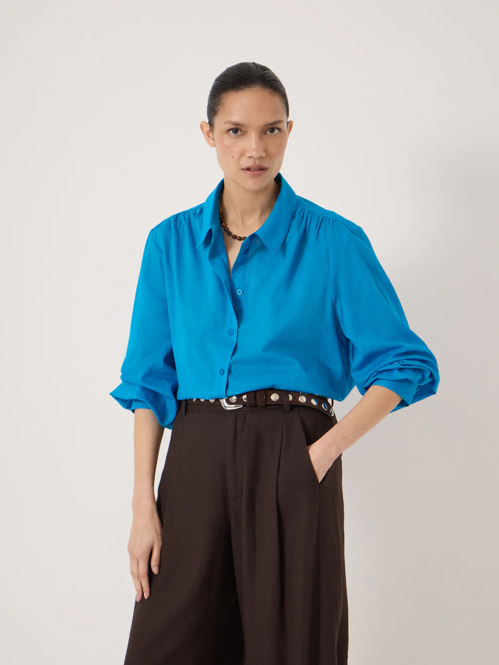 Bright blue loose-fitting voile shirt.