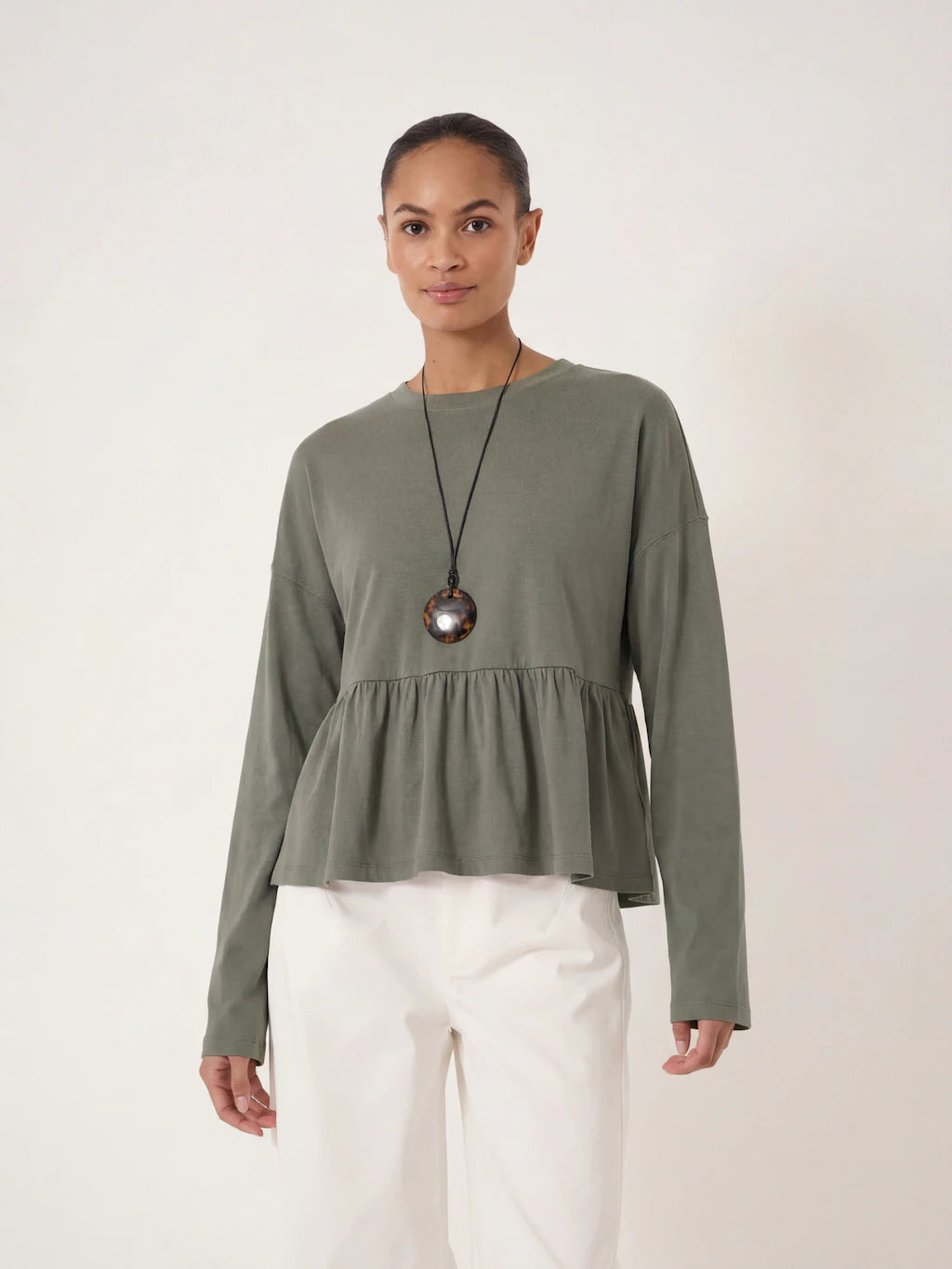 Soft khaki peplum long sleeved top.