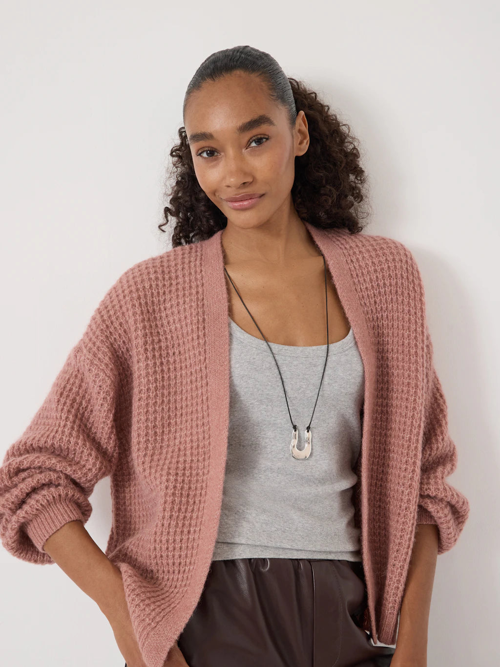 Rose pink waffle stitch edge-to-edge cardigan.