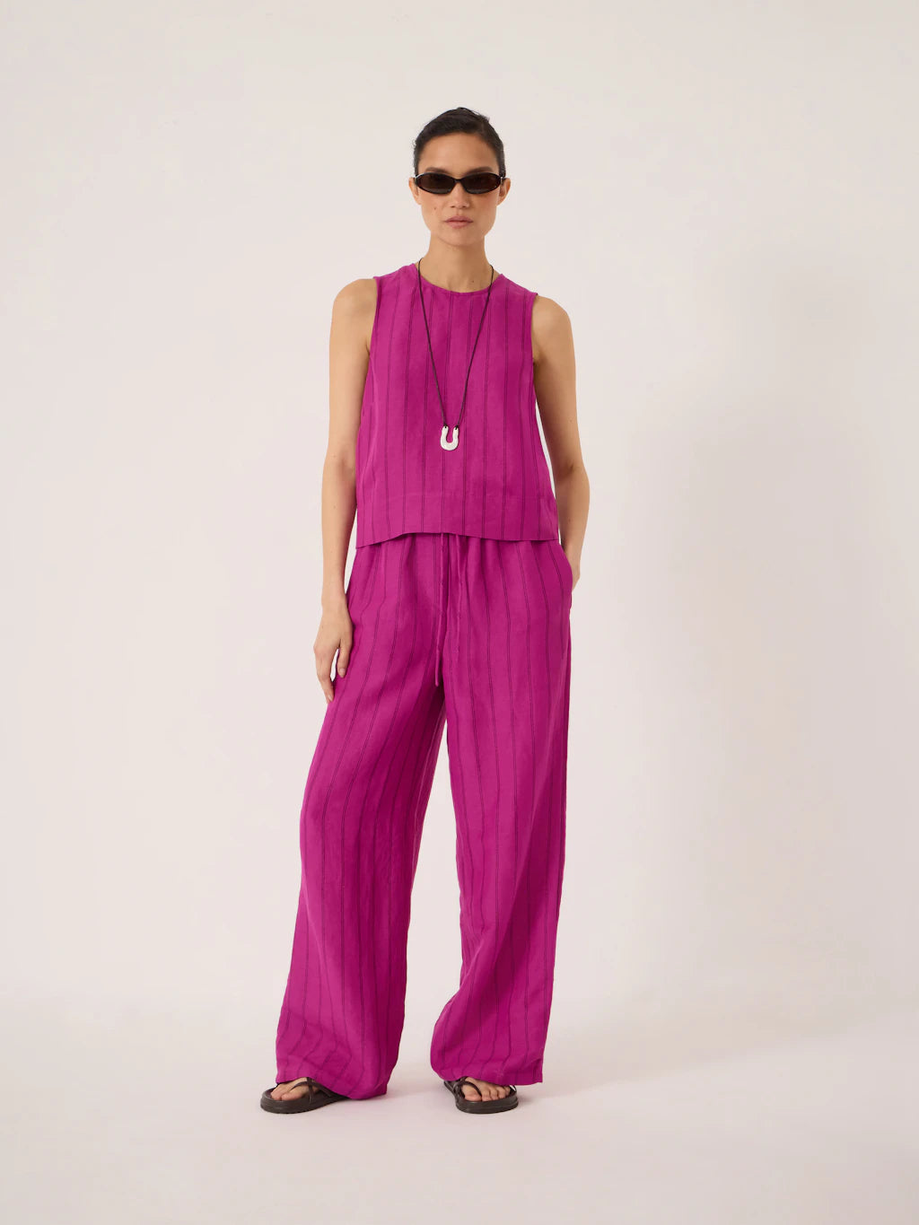 Deep magenta linen wide leg trousers.
