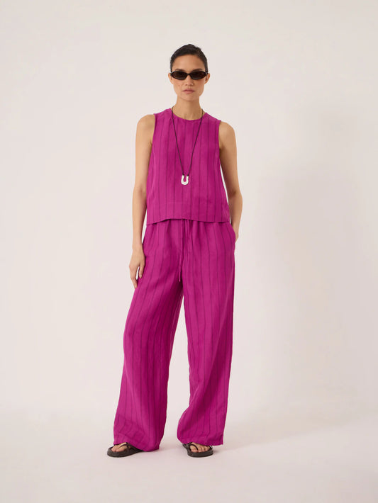 Deep magenta linen wide leg trousers.