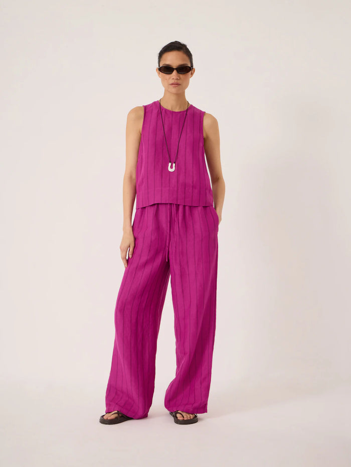 Deep magenta linen wide leg trousers.