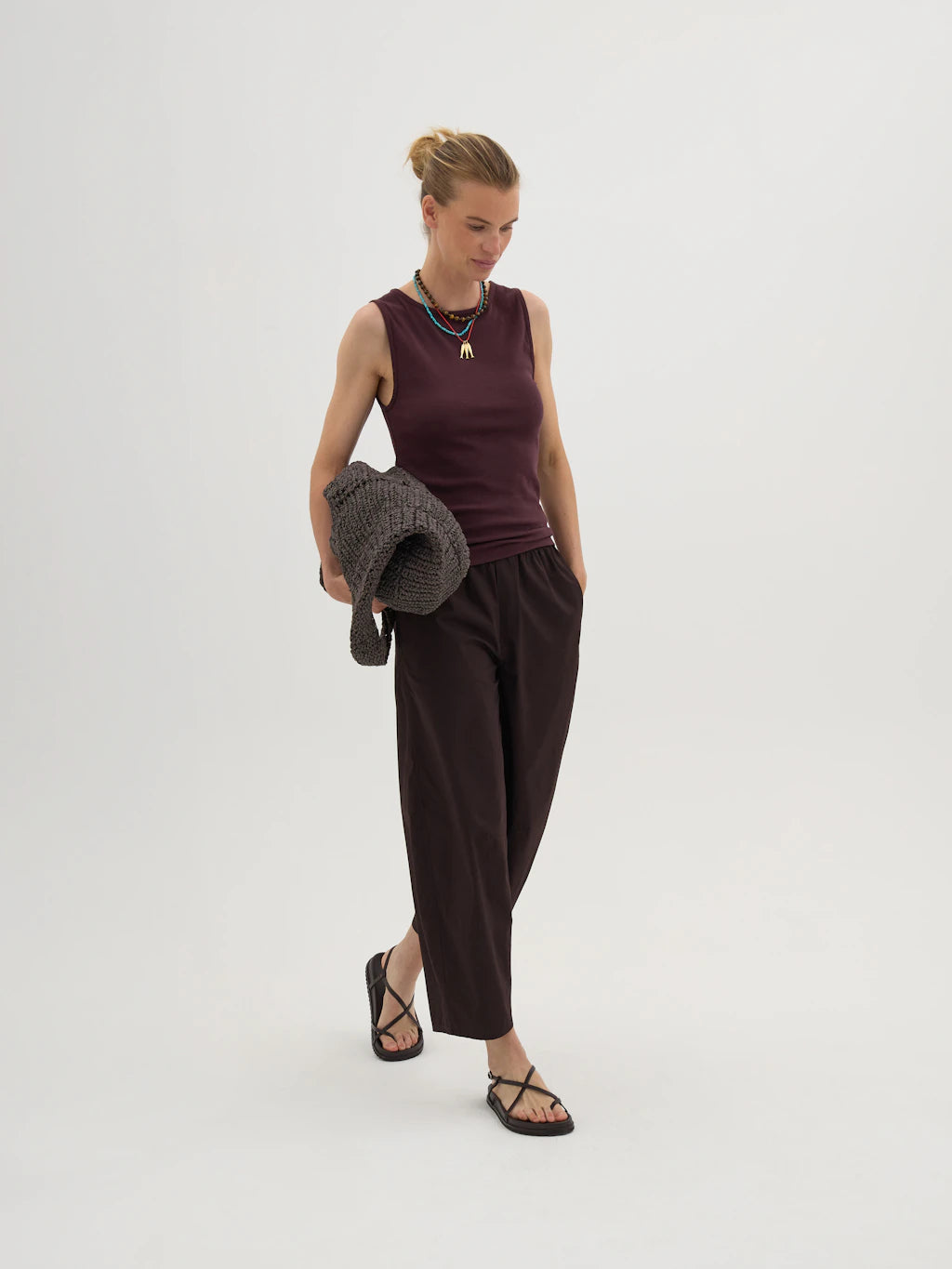 Dark brown cotton barrel leg trousers.