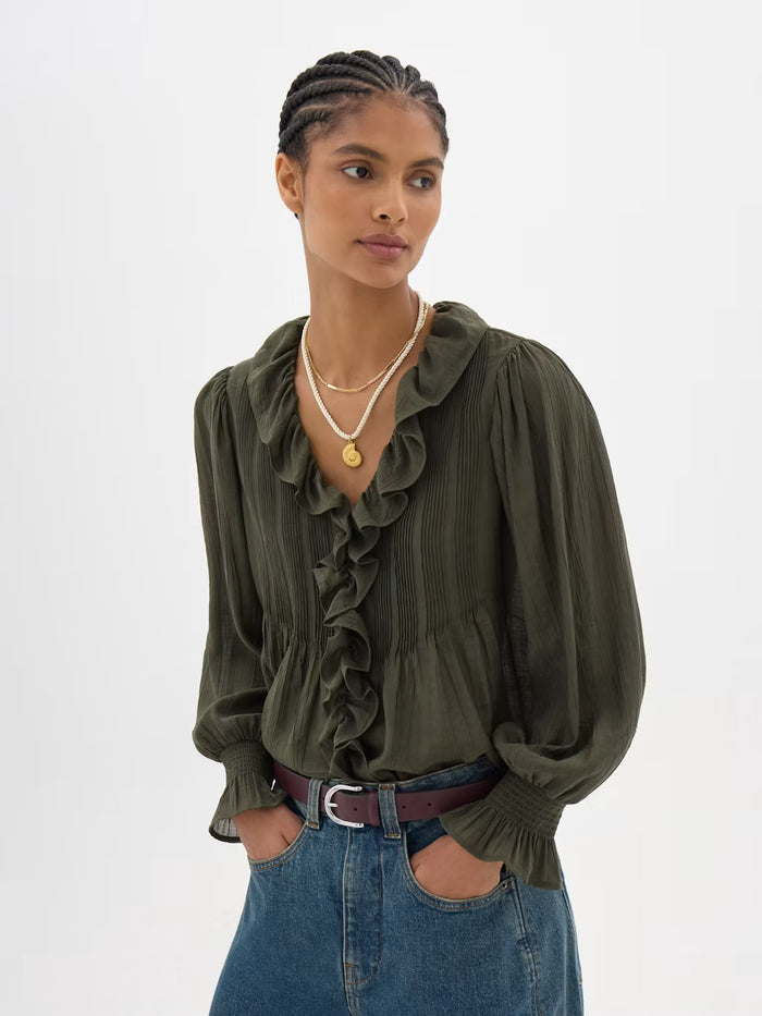 Olive ruffle blouse with long sleeves.
