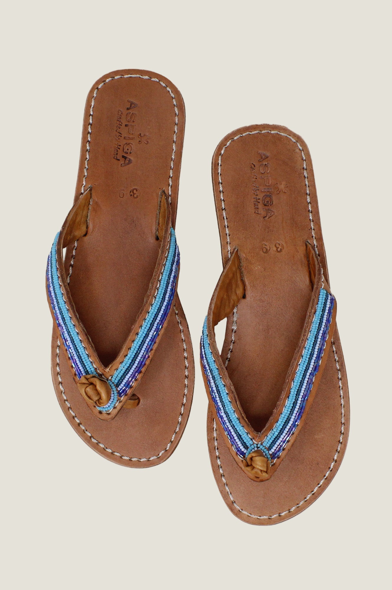 Tan leather flip-flop sandals with blue beaded strap detailing.