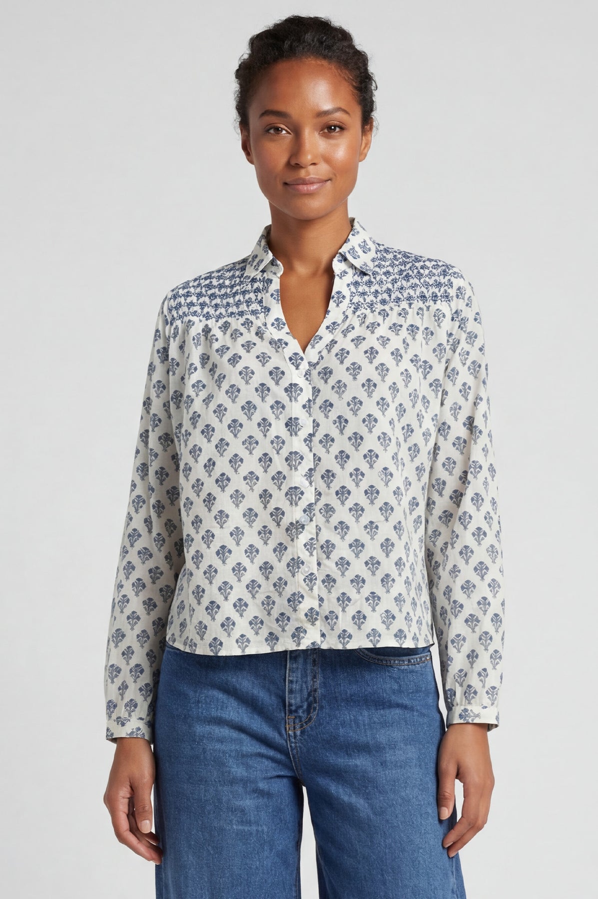 Organic cotton cream long-sleeve blouse with blue geometric floral print.